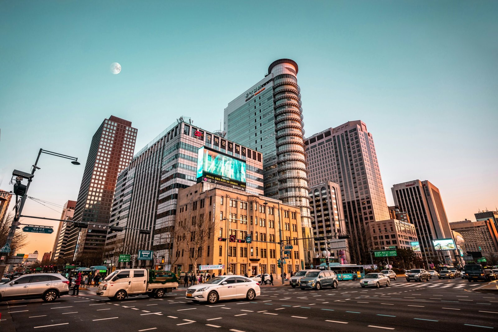cars on road near high rise buildings during daytime